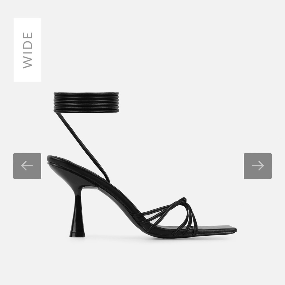 Black lace up heels. Featuring a square toe, knot tied upper and lace ups.